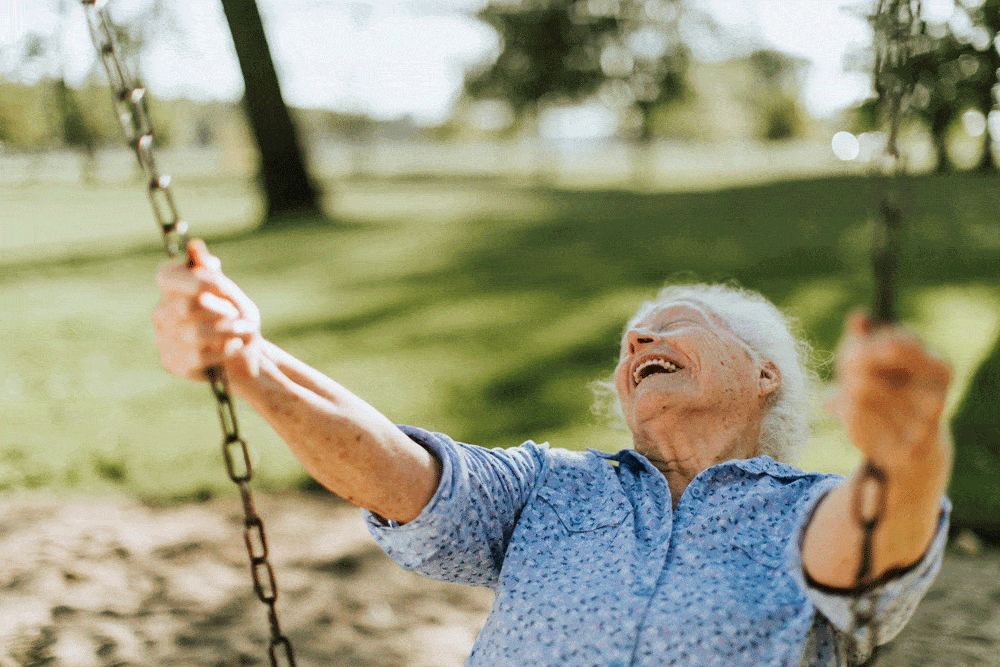 cheerful-senior-woman-swing-playground