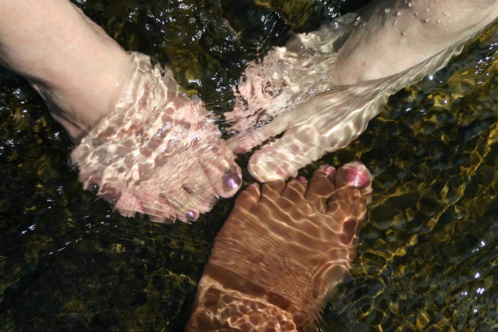 women feet in water