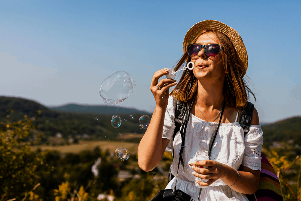 happy woman blowing bubbles