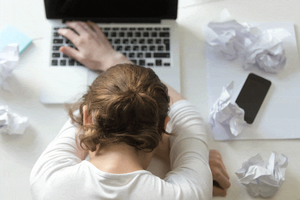 woman tired at work desk