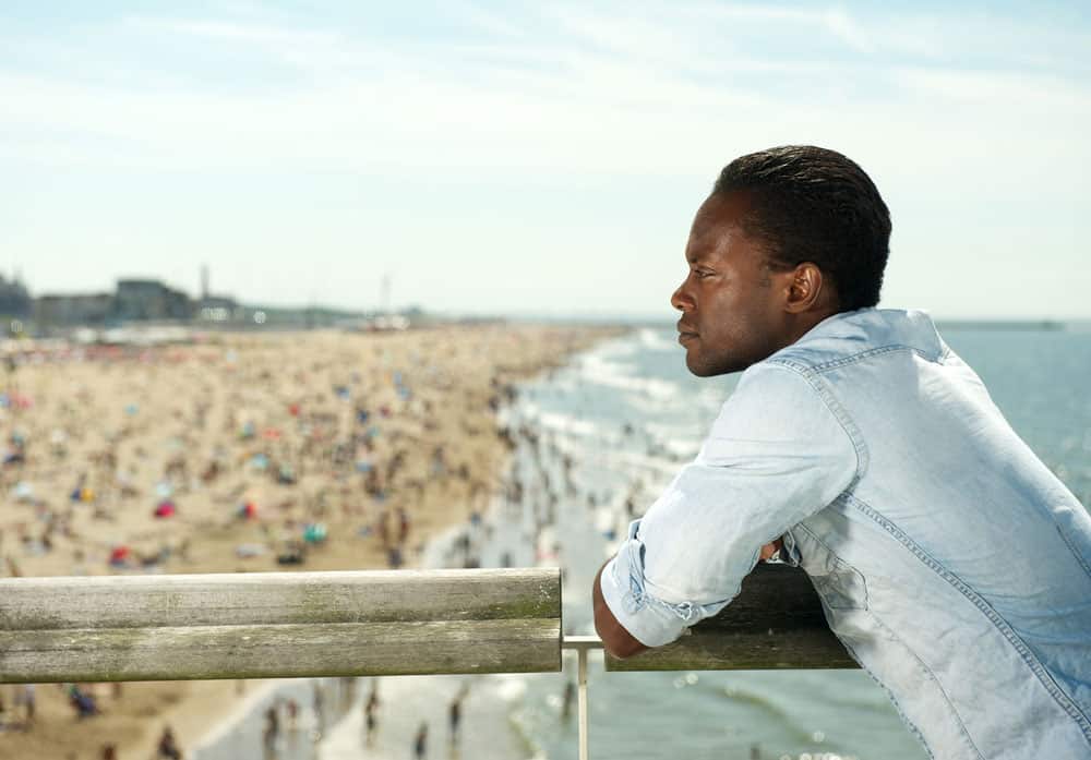 man-contemplating-at-beach