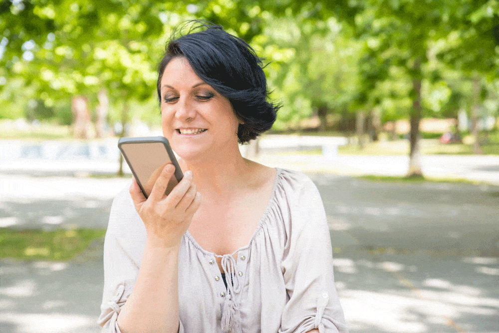 woman-smiling-holding-phone