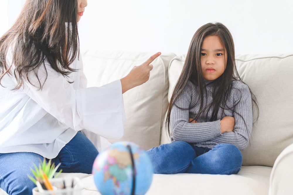 angry-asian-mother-sitting-with-little-daughter-mom-scolds-discipline-bad-behaviour-capricious-kid